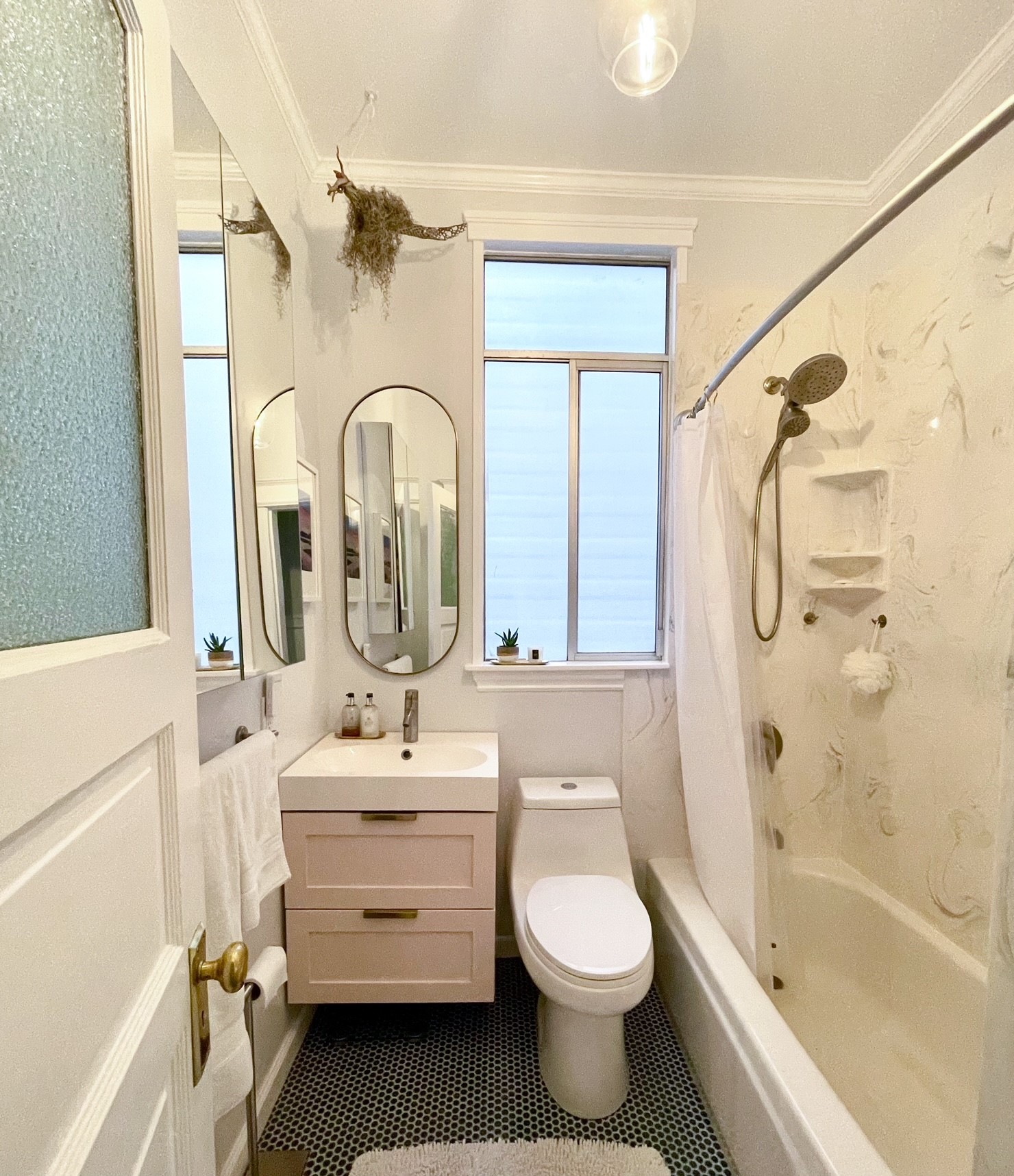 bathroom with blue penny tile and a pink vanity