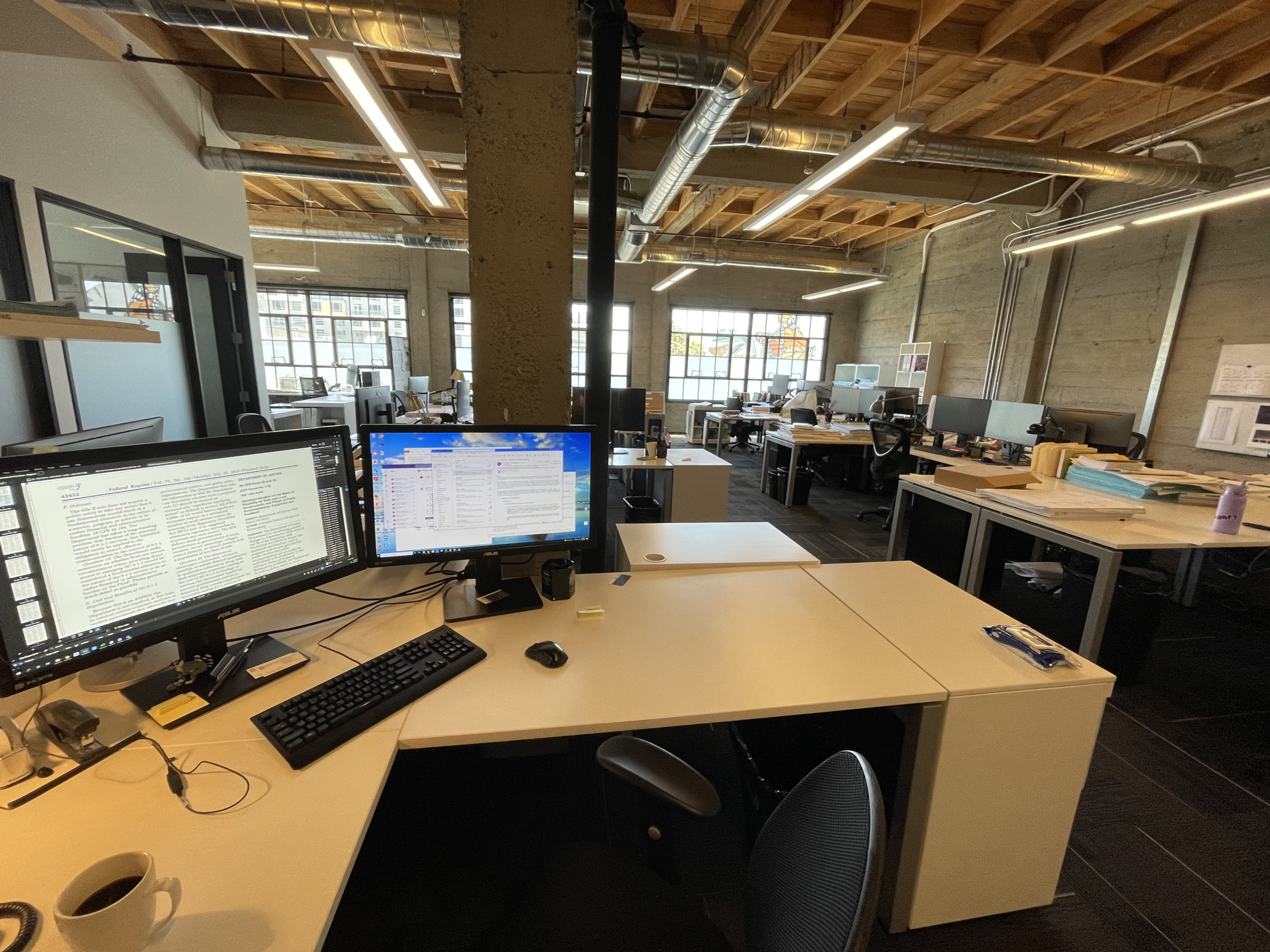 inside an empty architect office with wood ceilings and exposed mechanical ducts