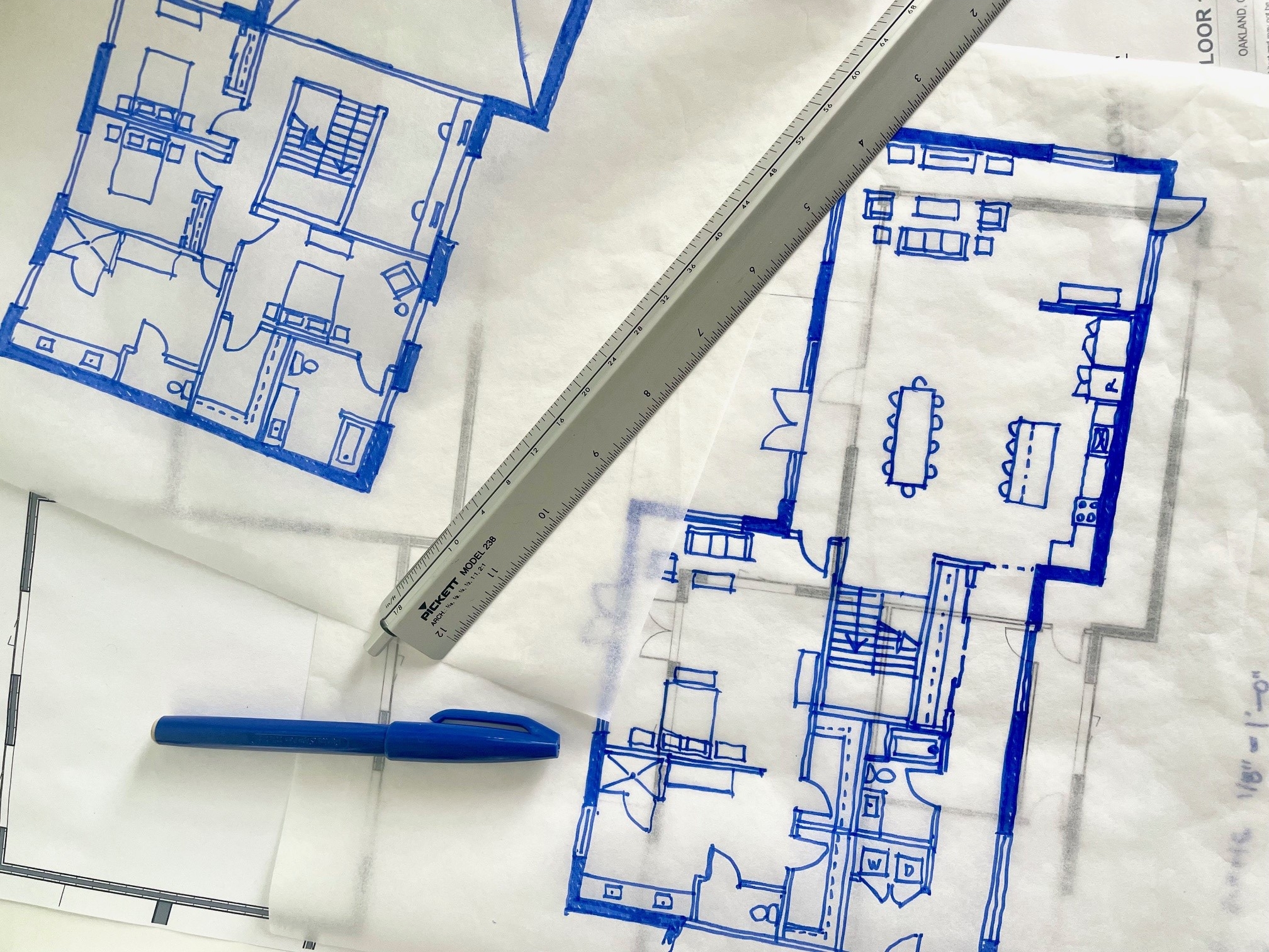 architect sketches of a new home on trace paper in blue ink