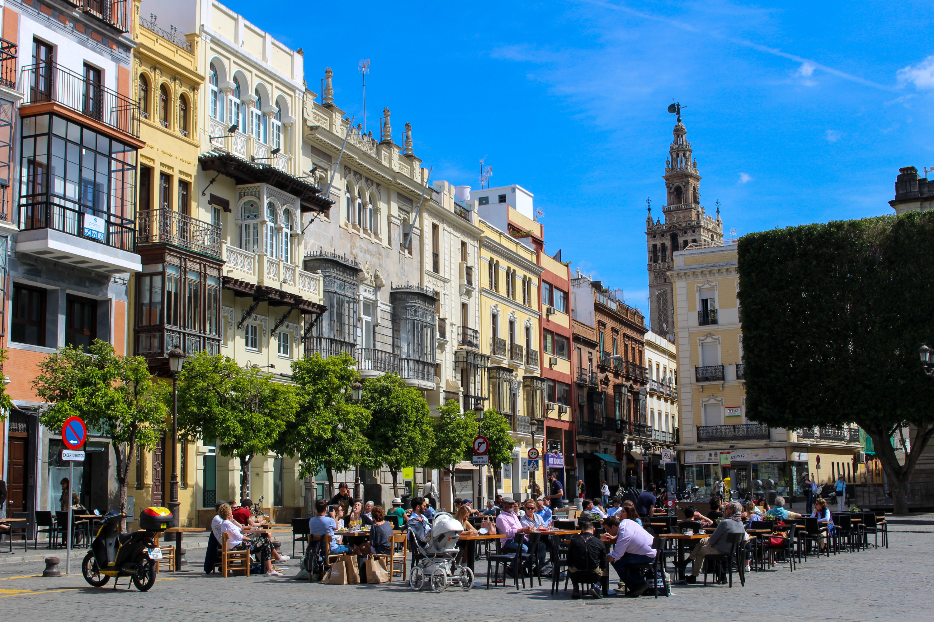 Outdoor dining and colorful buildings in Seville Spain