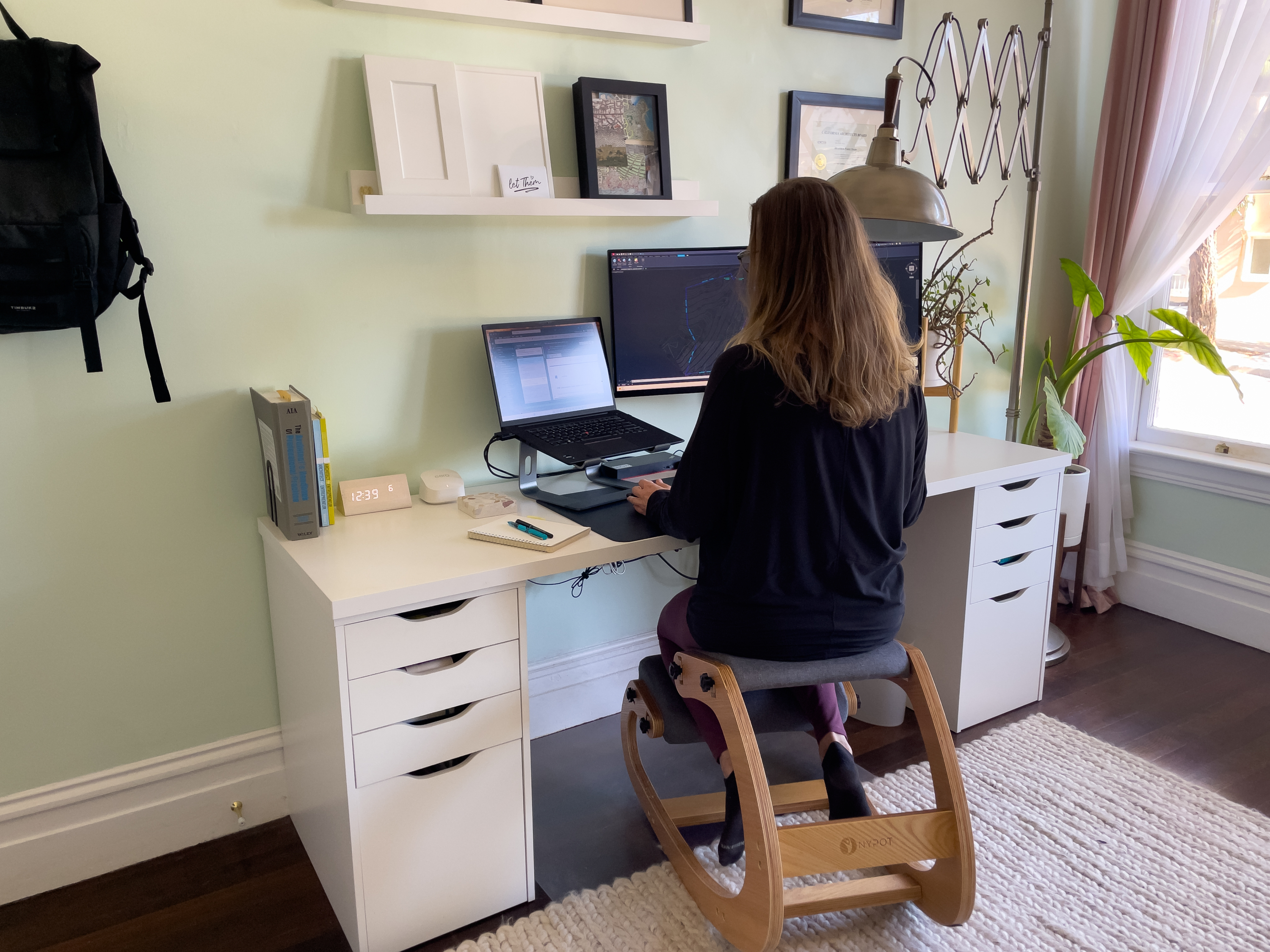 architect sitting at a white desk working from home
