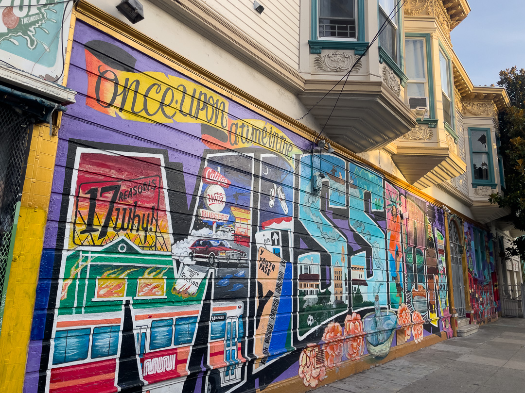 colorful mural in the mission district in san francisco at the corner of 24th street and shotwell, take a photo here on the mission burrito walking tour