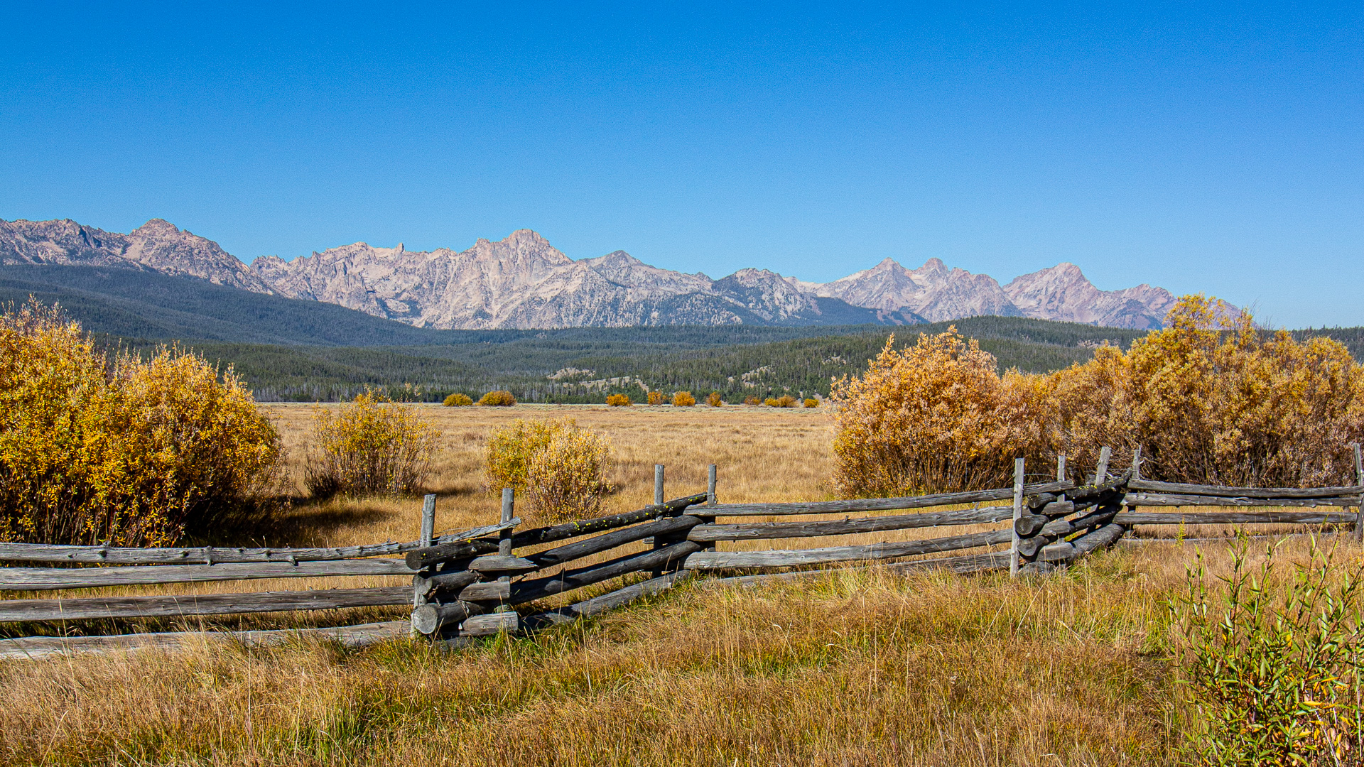 sawtooth mountains and a wood fence in fall near Stanley, Idaho, solo female travel, road trip