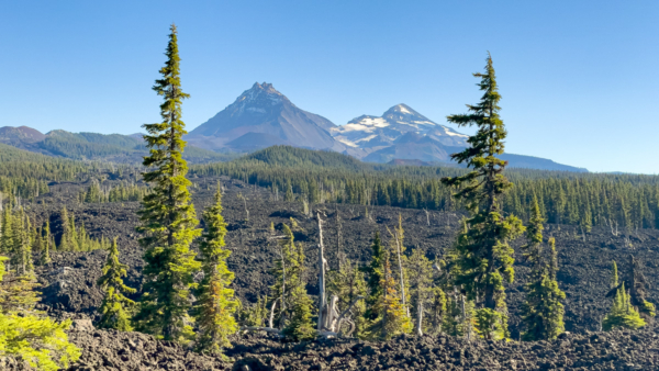 Looking towards the Sisters mountains near the Dee Wright Observatory on the McKenzie Scenic Pass Highway, day trip from Bend, things to do near Sisters, Oregon